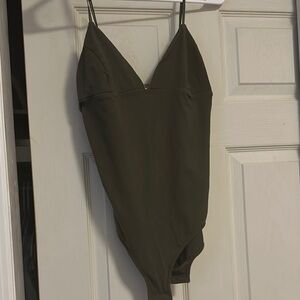 Out from under greeen bodysuit